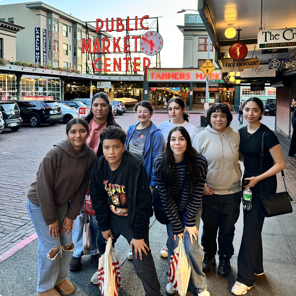 Group of people at a market entrance.