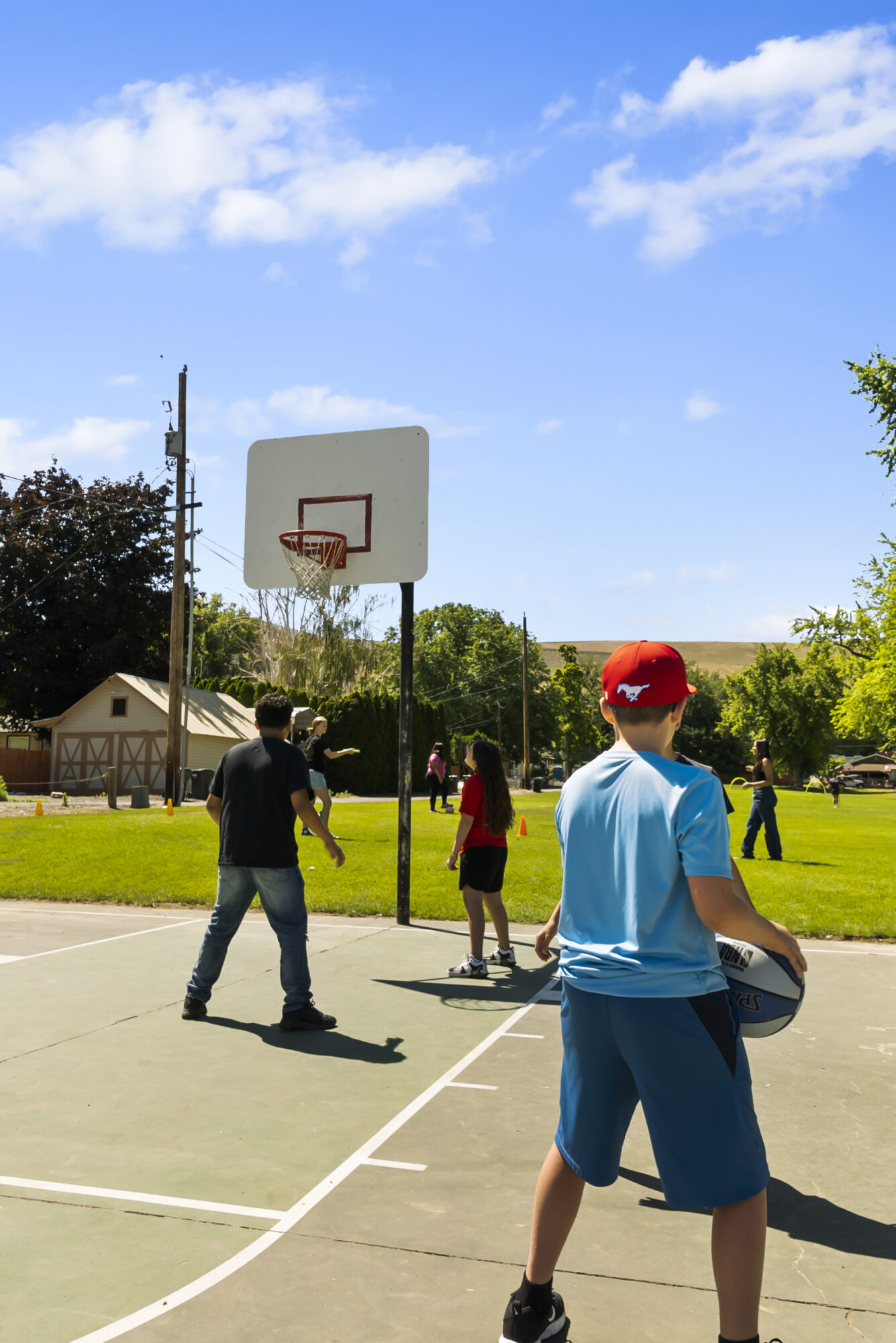 Kids playing basketball on outdoor court