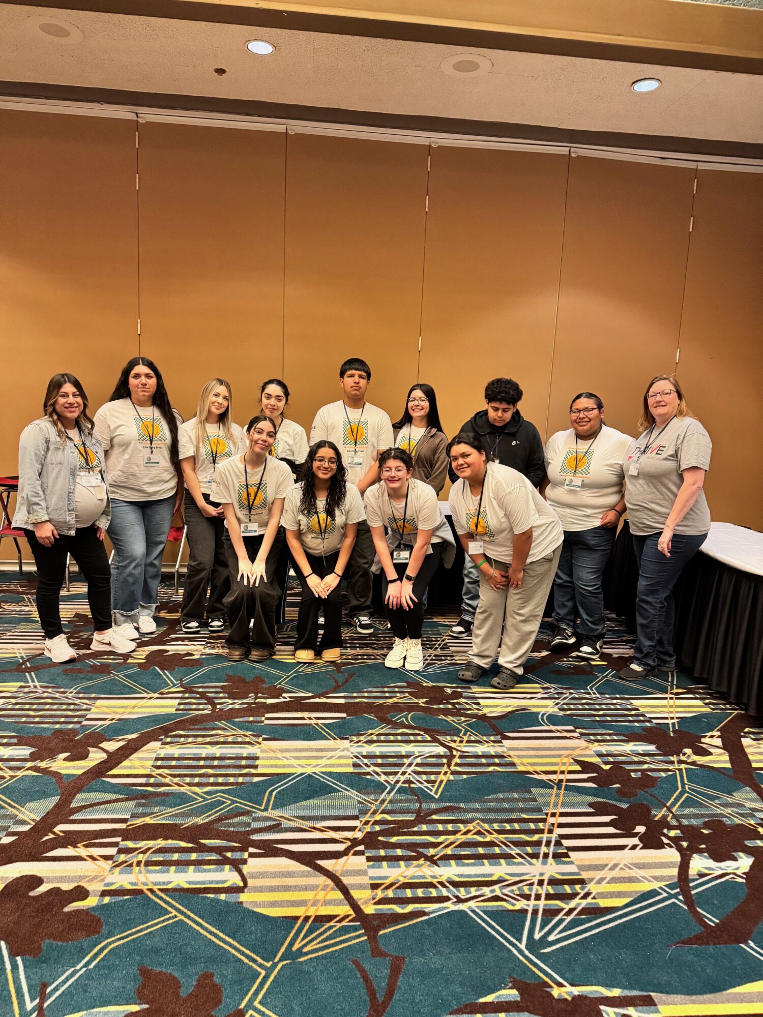 Group of people posing at an indoor event.