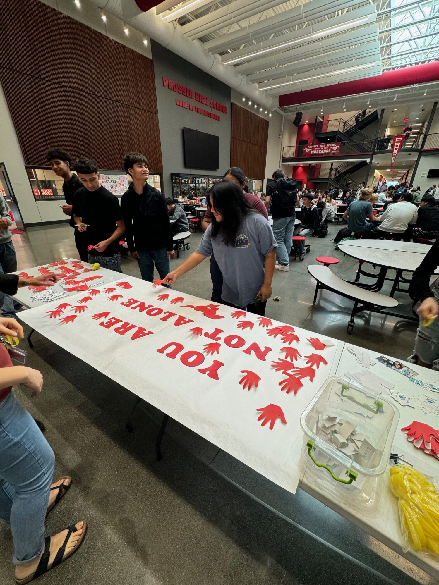 Students crafting 'You Are Not Alone' poster.