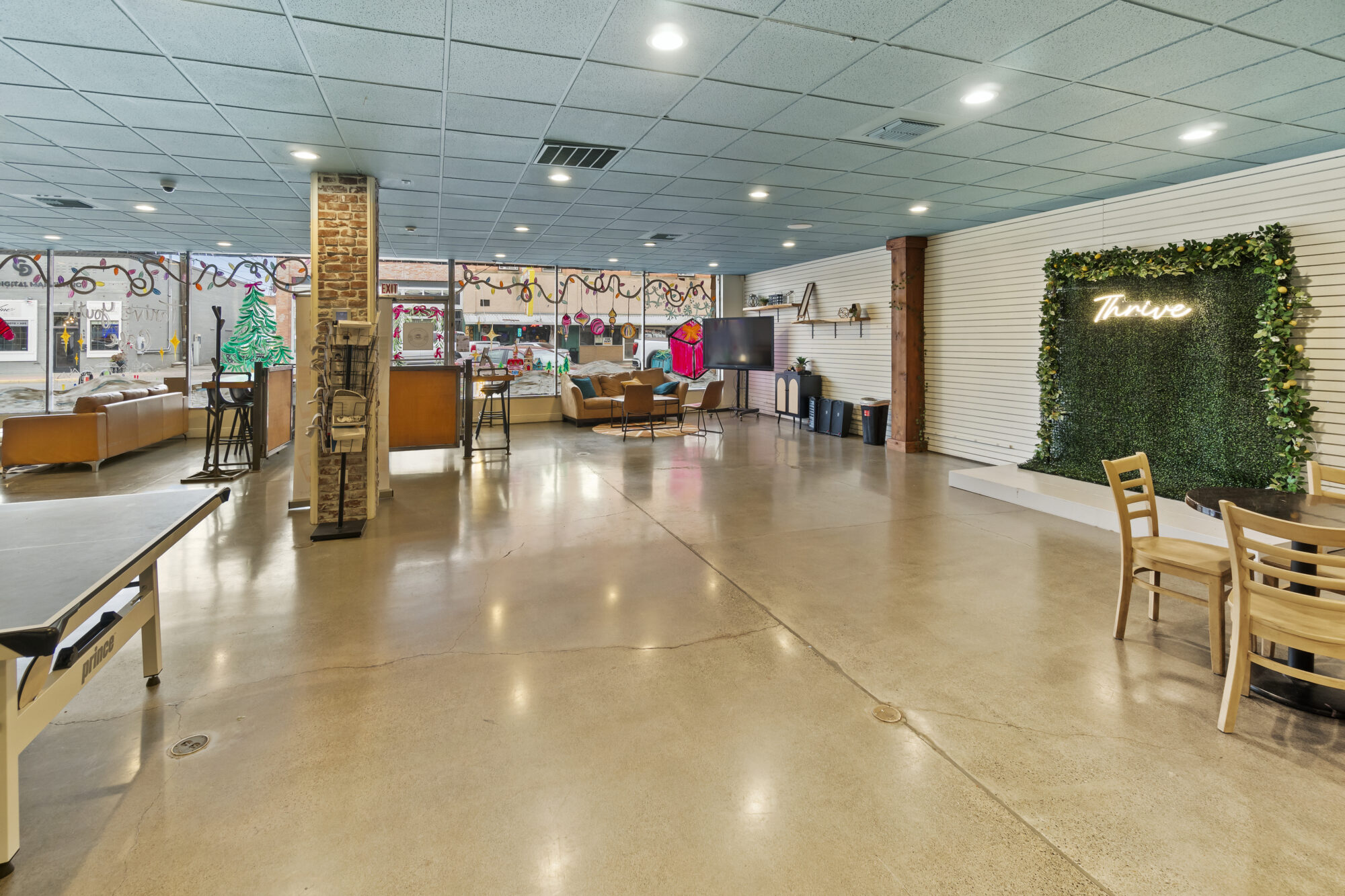 Spacious room with lounge area and thrive sign.