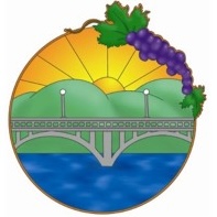 Sunset over bridge with grapes and river scene.