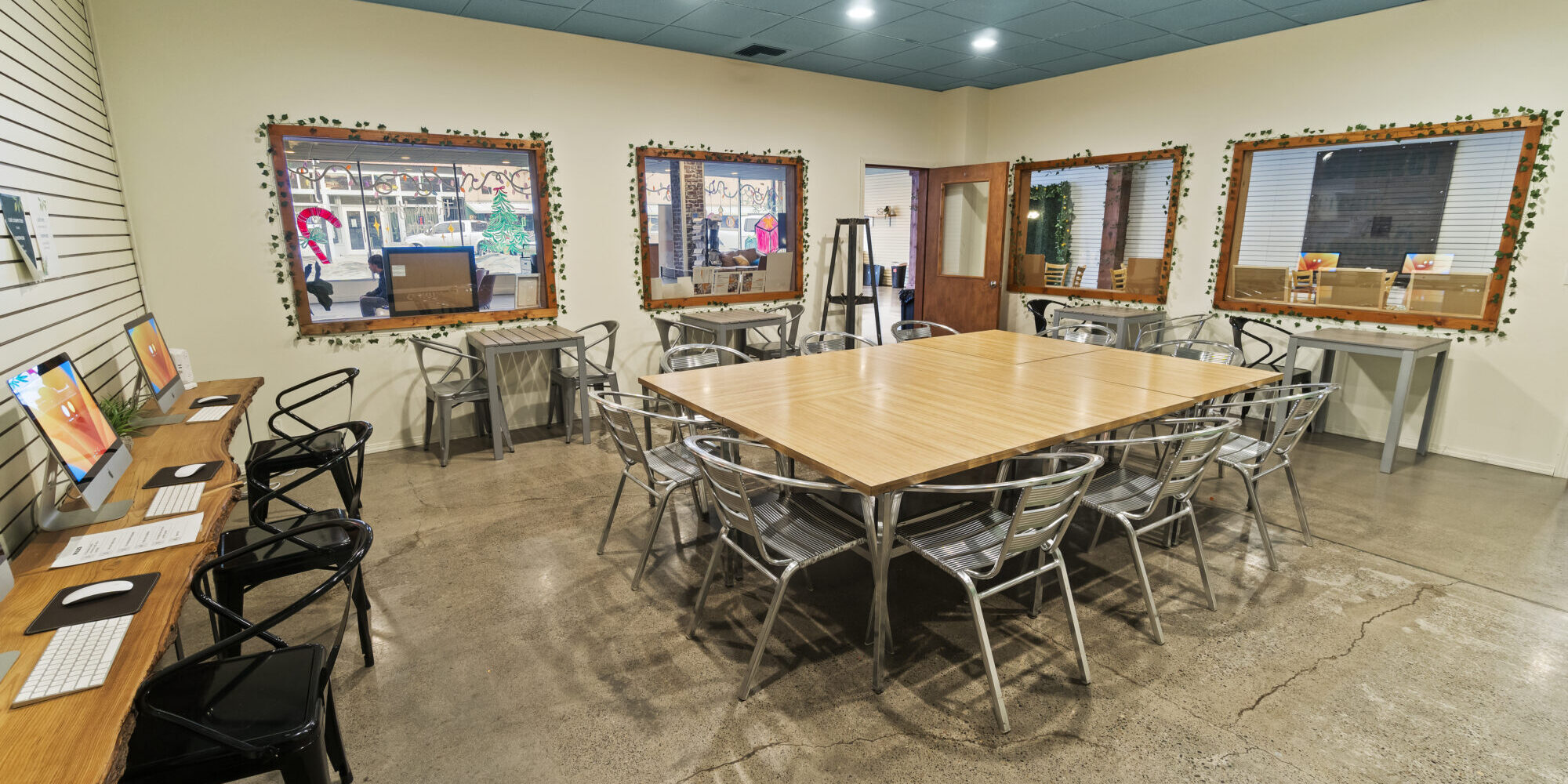 Spacious meeting room with computers and seating areas.